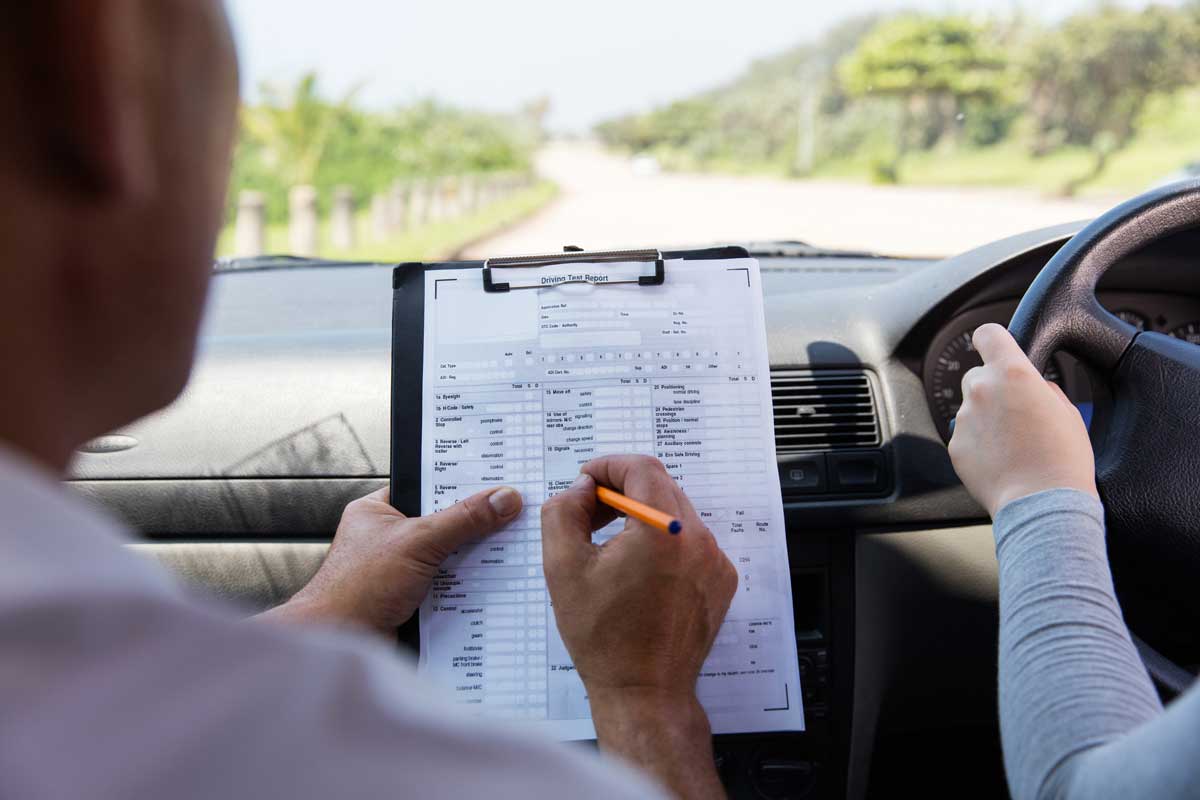 best driving instructor in Pakenham holding VicRoads driving test report in car